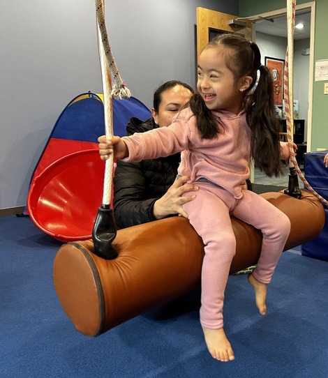 young girl on swing